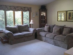 New couches purchased at Jordan's Furniture Outlet (Avon Store). Walls painted Powell Buff. Pictures centered behind couch. 