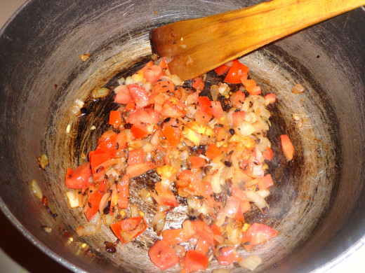 Chopped tomatoes added inside the pan for frying