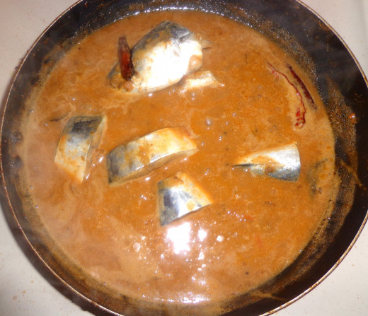 Fish pieces are added inside the curry