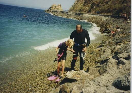 My daughter, Julie, and I prepare to enter the water and snorkel at Avalon, CA, 1995.