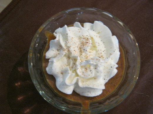 Serve warm, topped with whipped cream and a sprinkle of spice.