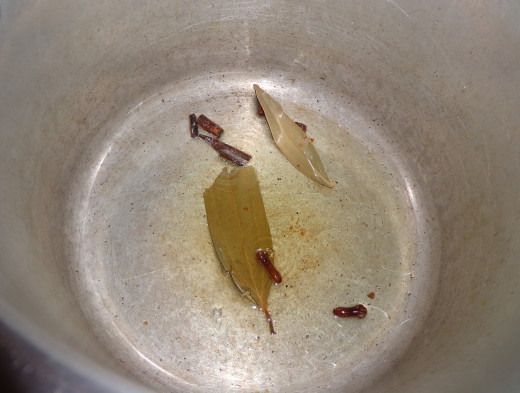 In a cooker pour oil and fry cinnamon stick, cloves, bay leaf and cardamom.