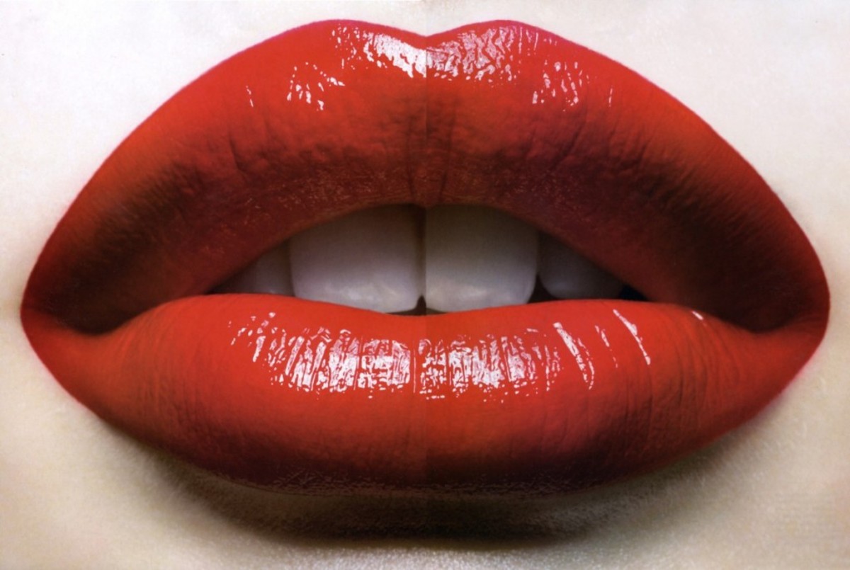 Red lips are the quintessential symbol & archetype of allure & seduction.  Nothing says it better. Red lips are used to sell everything from records and movies to t-shirts. Red lips are also enduring symbols of glamor & sophistication. 