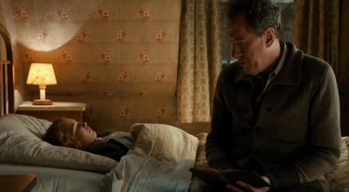 Papa comforts Liesel after a nightmare and discovers Liesel's book and that she cannot read.