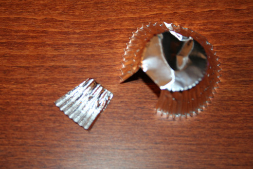 Cut a small piece from a mini paper baking cup to create the top of the ornament.