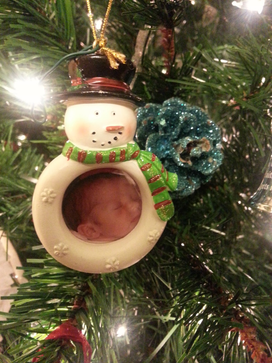 Photo ornament of my first granddaughter on her first Christmas.