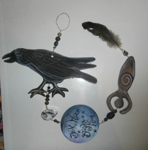 This "Dark Goddess" hanger features a large focal raven, various gemstones (one seated in sterling), a moon with text, a Goddess and a crow feather found in the woods.
