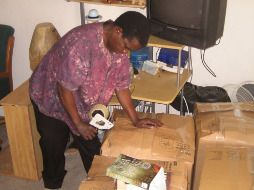 One of the founders of African Empowerment Communities helping in packaging.