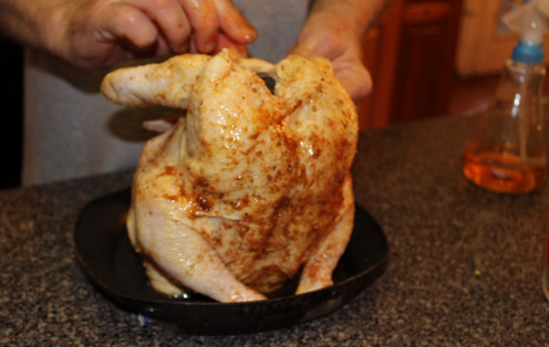 Place the top back onto the roaster that covers the well, then place the chicken over the top.