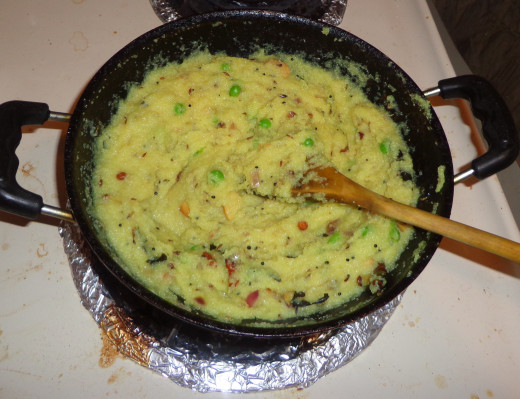 Semolina is added and stirred continuously.