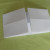 Bring the left and right flaps of the paper to the centre so that their edges align with the centre crease line. Bring the left and right flaps of the paper to the centre so that their edges align with the centre crease line.