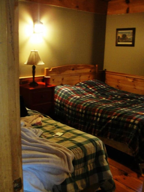 This bedroom is located to the right of the bathroom, just off screen. Don't mind the lighting. Poor quality camera. 