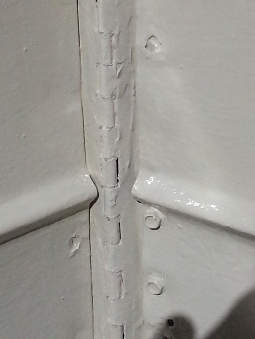 This is all very carefully, (if heavily) painted.  it was all prepped and cleaned well.  But, the metal here is TORN, along the length of the hinge, rusted, and very beaten in some spots.  More so in some spots.  But, it's well protected and preserve