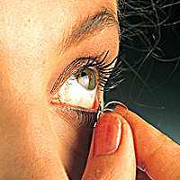 The lens should be held between the thumb and the index finger as it is pulled out from the surface of the eye