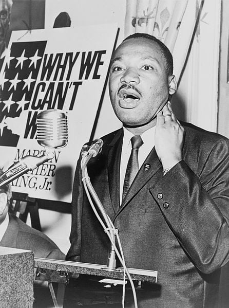 Martin Luther King Jr, photo taken on June 8, 1964.  He is at a press conference, and photo is taken by photo by Walter Albertin, and in the public domain. 