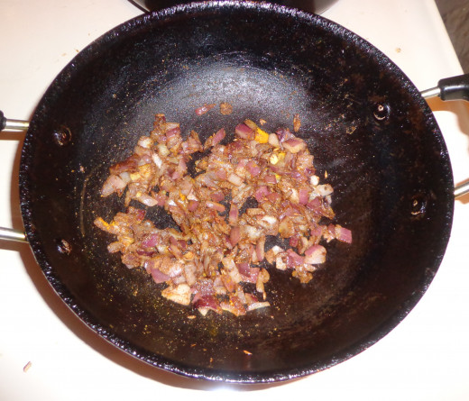 Onions turned golden brown and the red chilli powder, coriander powder is added inside and sautéed well