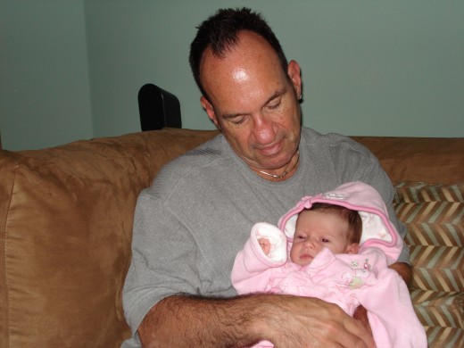 This is a picture of my father, Robert, holding my daughter, Fauna.