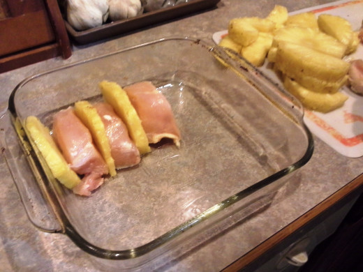 Step Nine: My husband was trying something new this time with his pineapple chicken; Layer your chicken and pineapple slices into your casserole