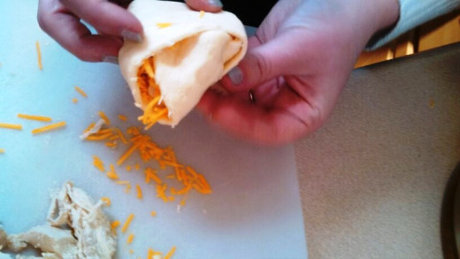 Step Four: Roll over the sides of each of your crescent rolls over the toppings