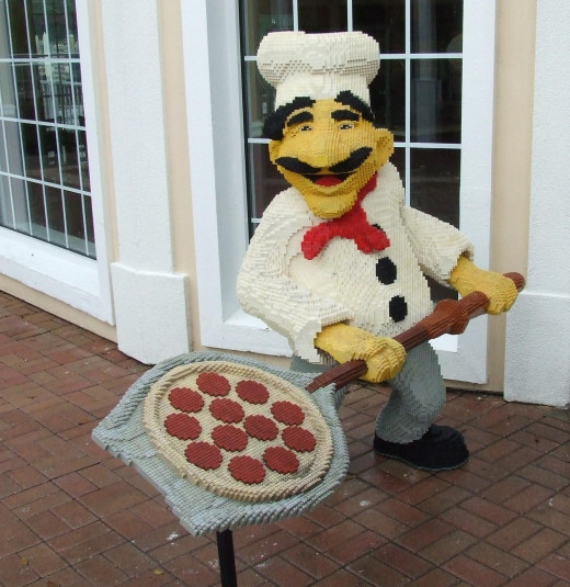 A chef statue at the entrance of a restaurant. 