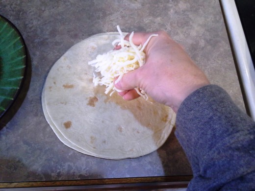 Step Seven: On the side, cover one tortilla with cheese