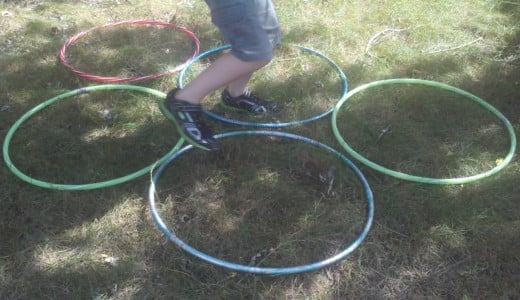 An obstacle course event can include running through rings, aka hula hoops.