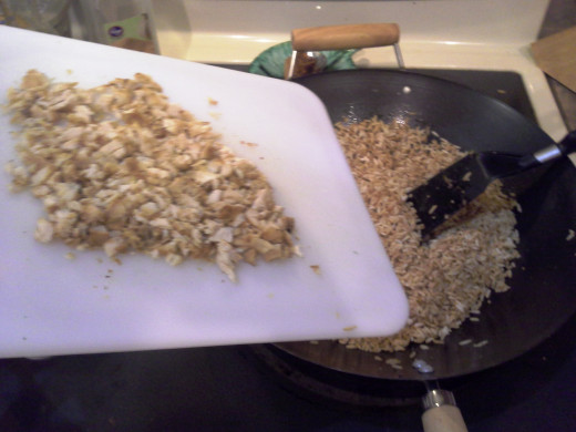 Step Thirty: I finely chopped some previously cooked chicken from another recipe and added it to my cooked rice in the Wok