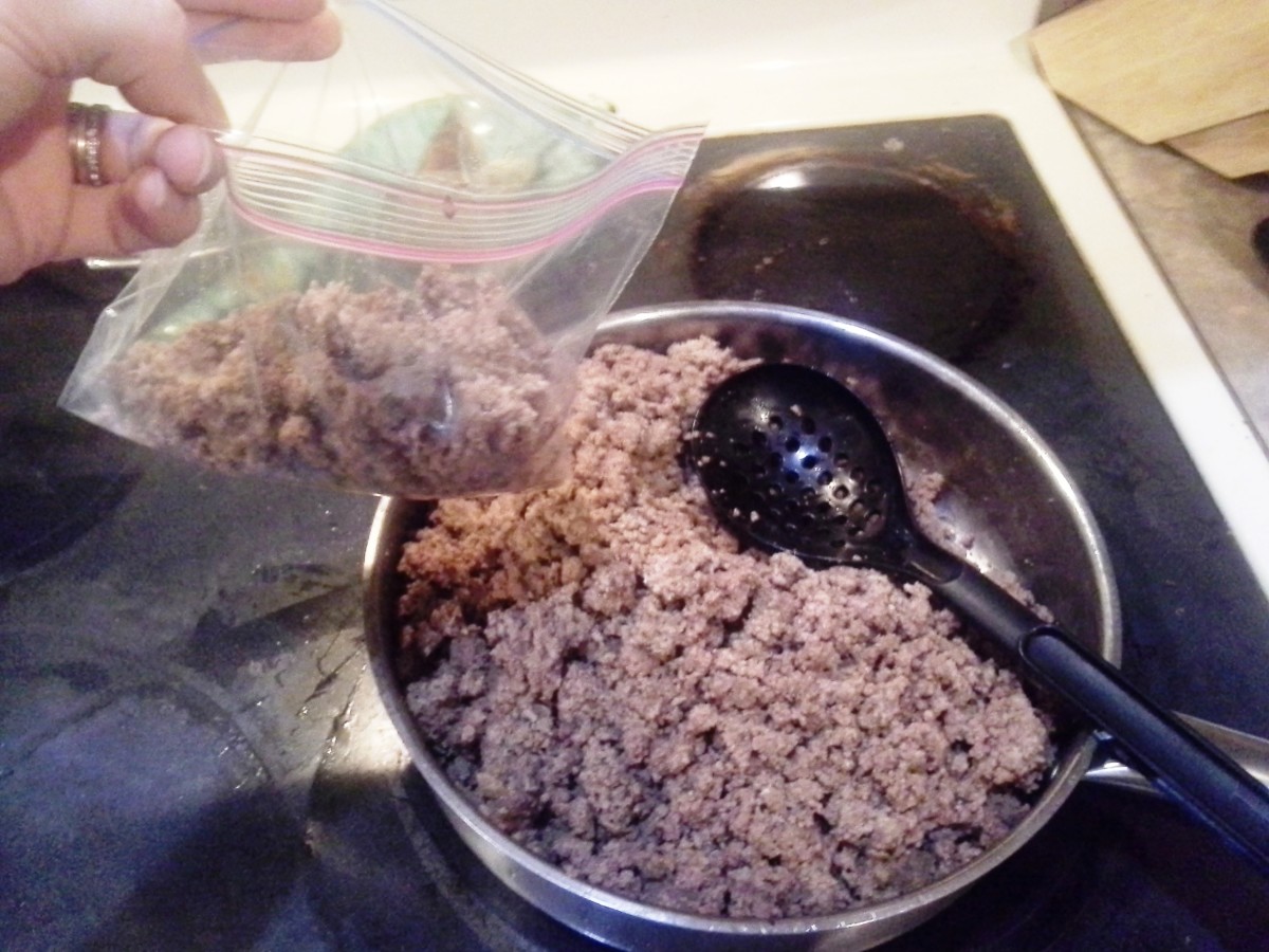 Step Fourteen: Begin by spooning out 1 or 2 spoonfuls of hamburger into each bag with a large serving spoon
