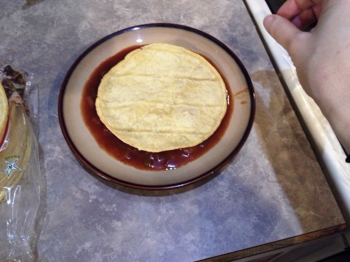 Step Fourteen: Dip one side of each corn tortilla into your red sauce