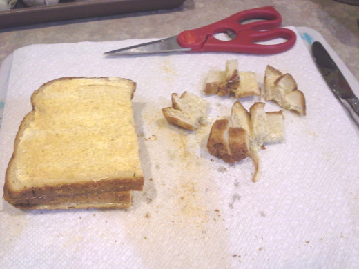 Step Six: Using kitchen scissors, cut your bread slices into small little bread chunks