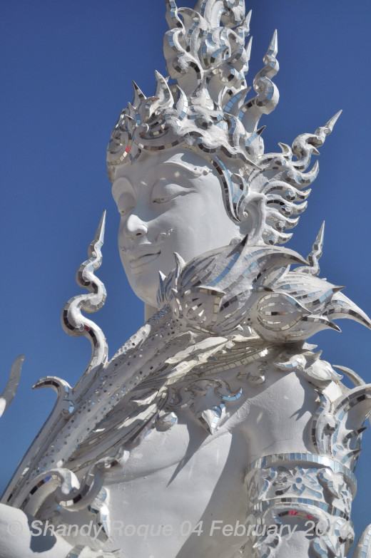 The Kinnon, a mystical creature than represents eternal love, stands by the entrance of the table. Location: Wat Rong Khun (The White Temple)