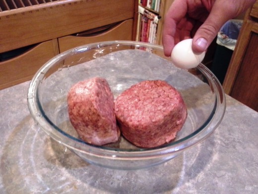 Step Three: Once thawed, pour your hamburger meat into a large mixing bowl and add your egg