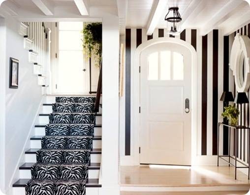 bold striped walls in black and white with a stairway runner in disctincitve black and white