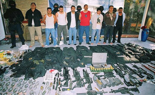 Captured gang members and their weapons
