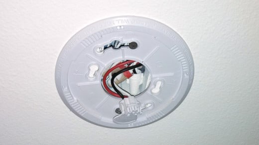 Wired CO detectors can be easily unplugged from the wire harness.  This allows access to the battery compartment.