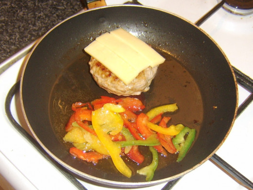 Cheese is laid on spicy pork burger