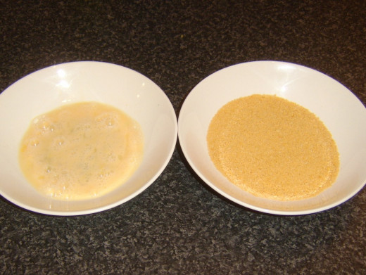 Beaten egg and golden breadcrumbs for dressing potato cakes