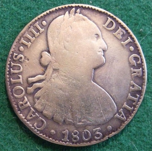 A Spanish silver dollar, also known as a piece of eight because it divides into 8 reales. 