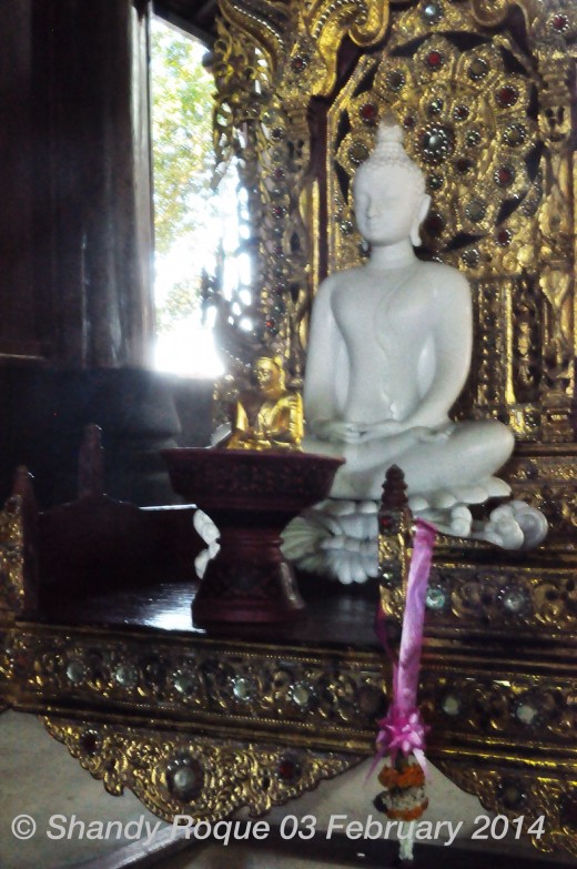 In another section of Baan Dam's main house is a peaceful white Buddha on a golden throne as if a reminder that there is a piece of heaven awaiting in the midst of hell.