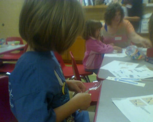 My daughter making a craft at the library