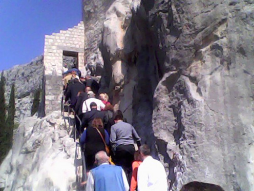 The entrance of the castle with many people climbing up to see the interesting treasures and to know more about the  intriguing history