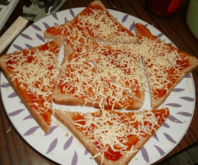 Generously topping the pizza with cheese