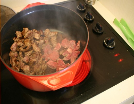 Push the cooked pieces to the side and cook the next batch.  Note the pot is scooted partially off the burner. 