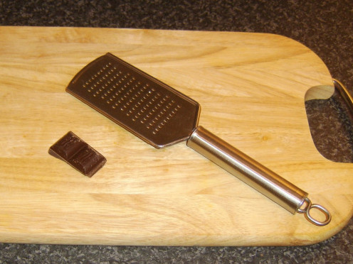 Hand grater is used to grate chocolate for garnishing