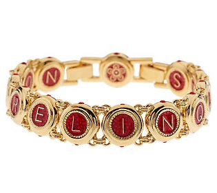 Red epoxy enamel and highly polished letters spell out in Latin, "I will not give up on you" on one side of this elegant bracelet, and "You will not give up on me" on the other. Single simulated rubies on top and along the bottom sides of the round l