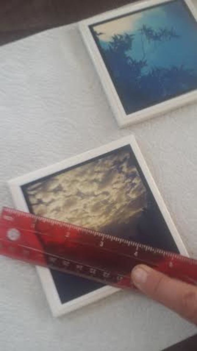 Use a ruler to help securely adhere photos to the tiles and remove excess glue
