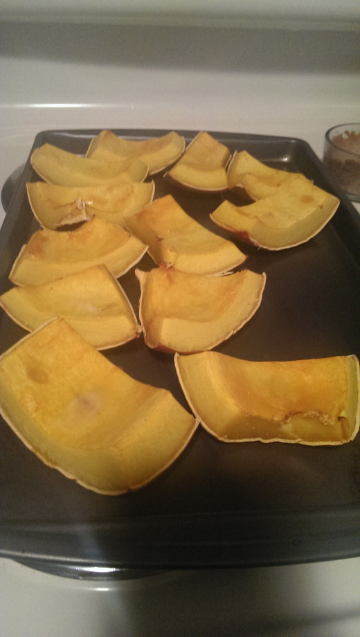 here are the pieces cut up, and this is what they look like after baking - slightly browned, peeling, hard crust, and soft to the touch of a spoon or fork. check your pumkin pieces often to make sure they don't overcook.