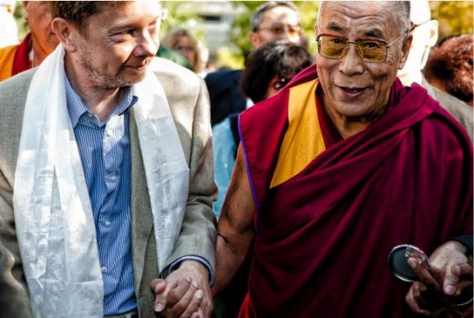 The Dalai Lama and Eckhart Tolle walking together.