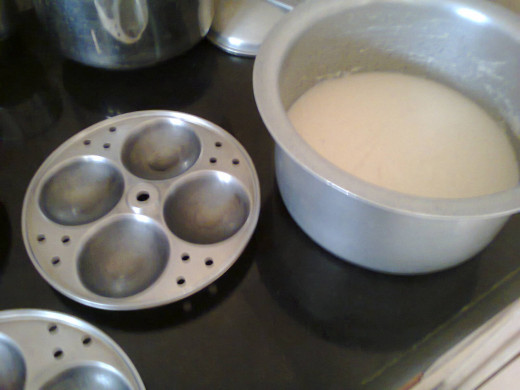 Idli plates with oil to be applied and idli mixture kept ready for preparation