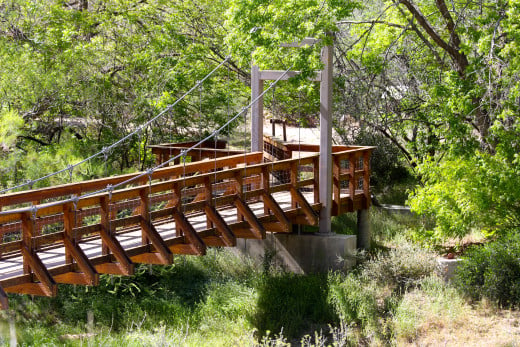 Footbridges, including this lovely swaying suspension bridge, cross creeks and washes.